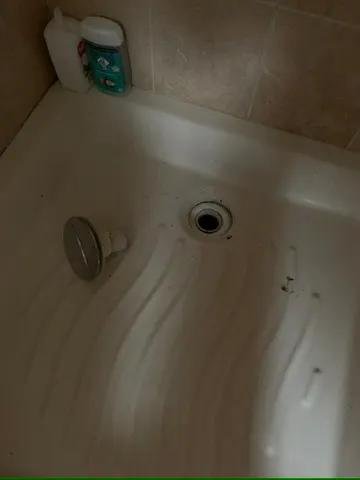 Fond de receveur de douche avec bonde démontée pour débouchage du siphon, intervention AS Depann dans une salle de bain